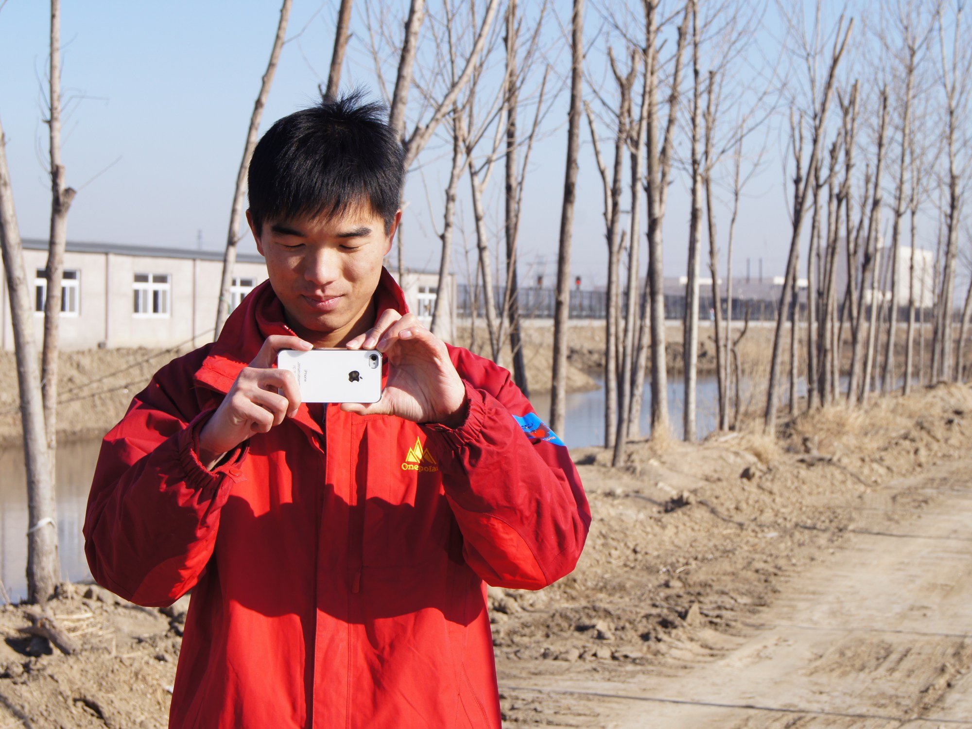 An environmental activist takes a cellphone photo