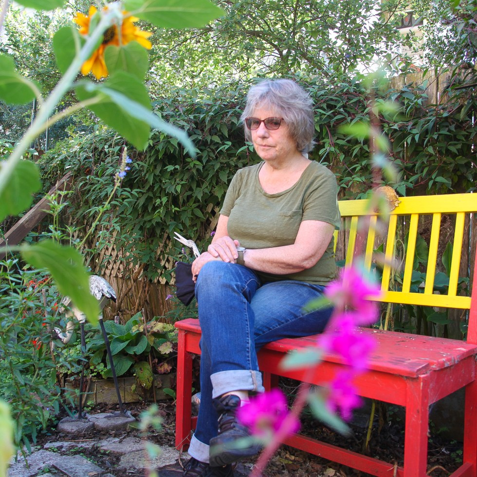 Teresa Palmer sitting in backyard